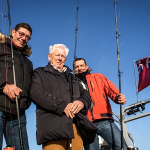 a couple of people that are standing in the snow