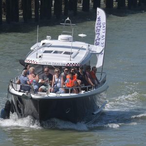 a group of people in a small boat in a body of water